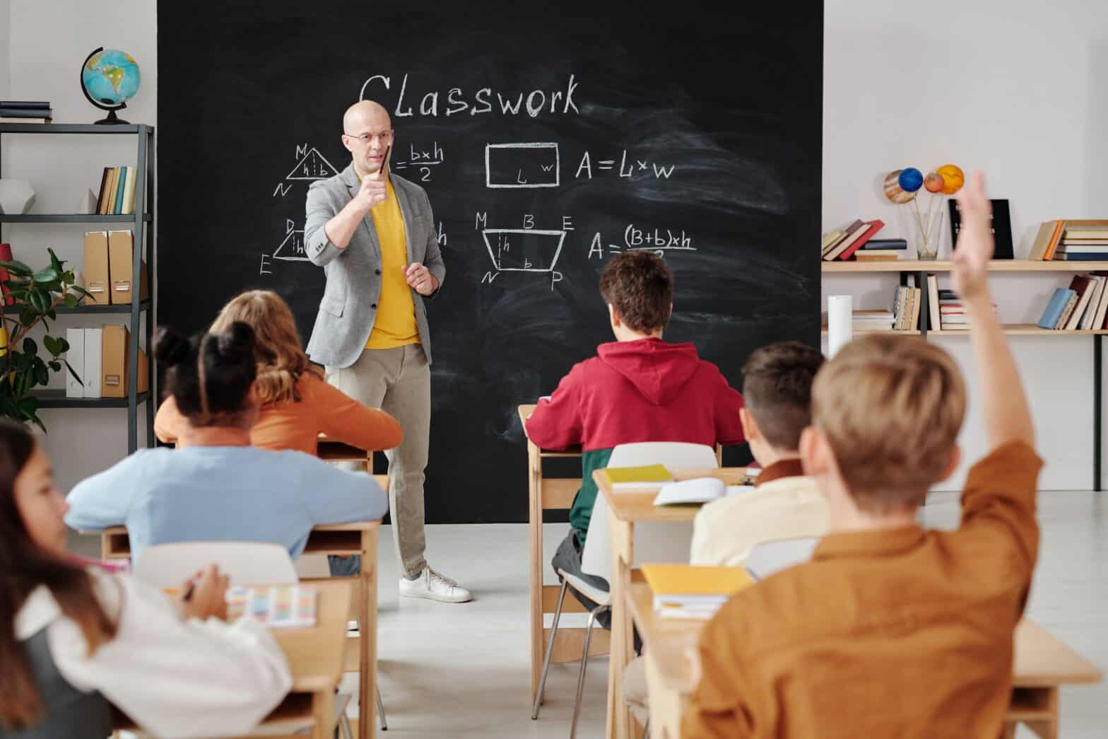 Teacher in front of class calling on student